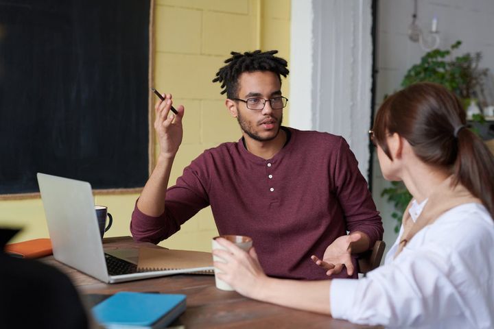 Photo of a man holding a pen