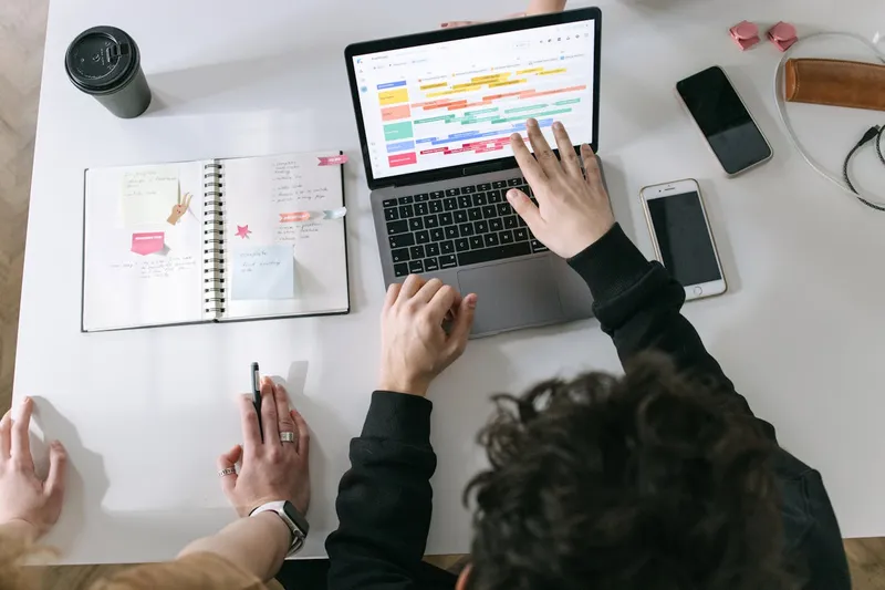 A person in black long sleeve shirt using a laptop